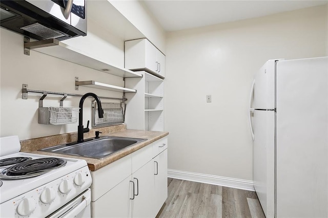 kitchen featuring white appliances, sink, light hardwood / wood-style flooring, and white cabinetry