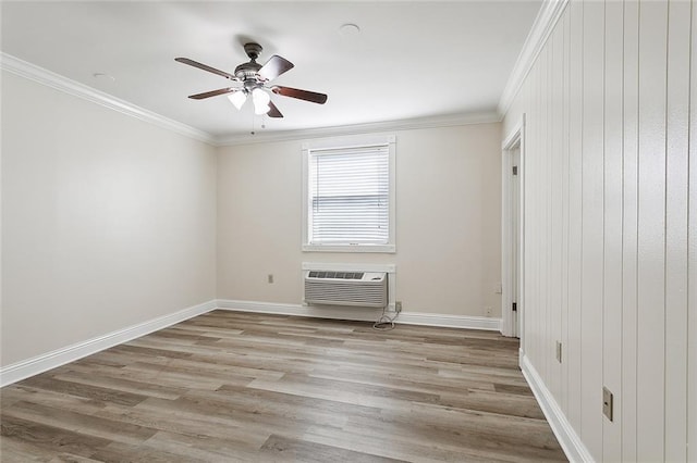 spare room with ornamental molding, ceiling fan, light wood-type flooring, and an AC wall unit