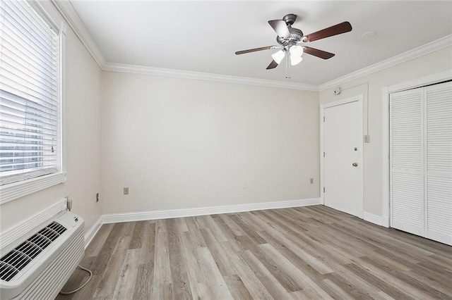 unfurnished bedroom with a wall unit AC, a closet, light wood-type flooring, ceiling fan, and ornamental molding