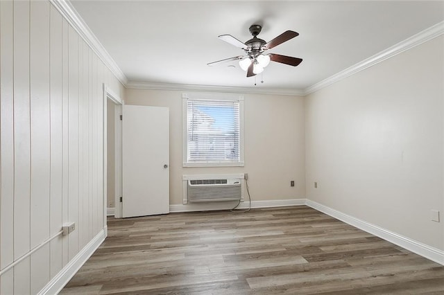 unfurnished room featuring ceiling fan, light hardwood / wood-style flooring, crown molding, and an AC wall unit