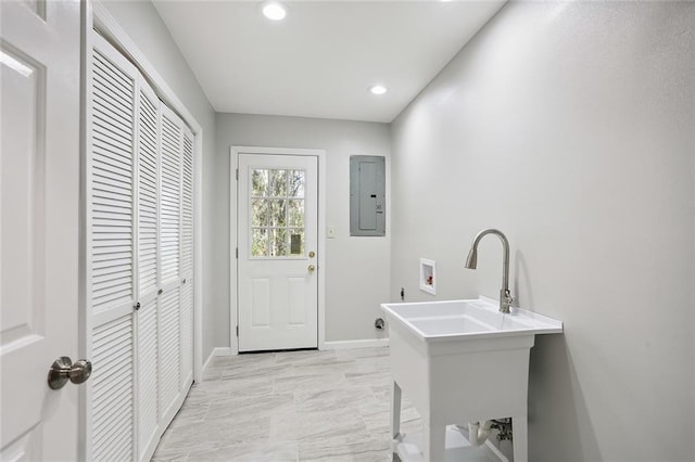 laundry room featuring electric panel and washer hookup