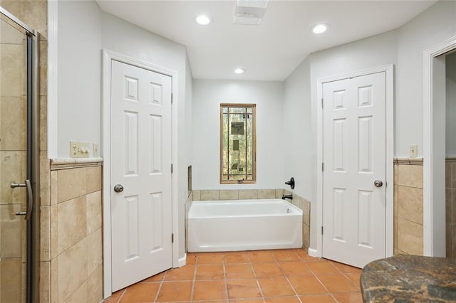 bathroom featuring tile patterned flooring and plus walk in shower