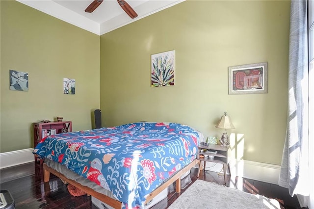 bedroom featuring crown molding, ceiling fan, and dark wood-type flooring