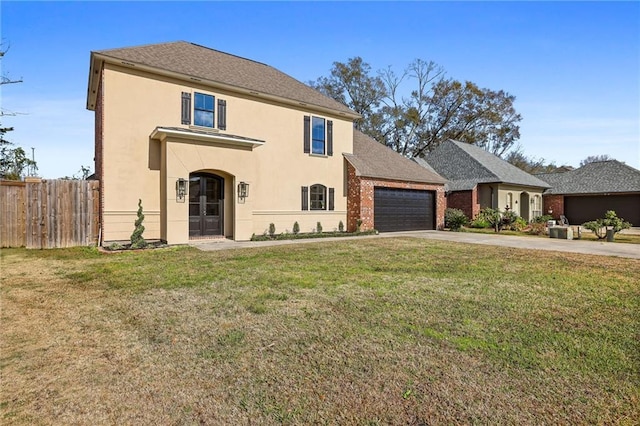 view of front of house featuring a front lawn and a garage