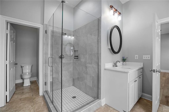 bathroom with vanity, toilet, and an enclosed shower