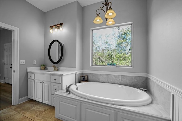 bathroom featuring tile patterned floors, a bathing tub, and vanity