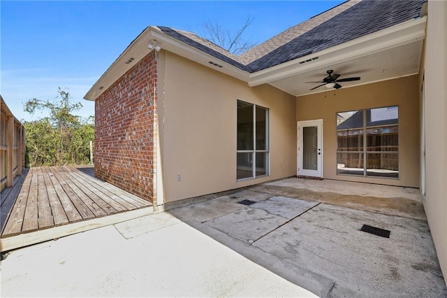 back of property with ceiling fan, a patio area, and a wooden deck