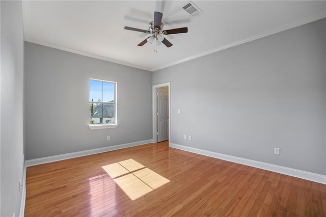 spare room featuring crown molding, ceiling fan, and light wood-type flooring