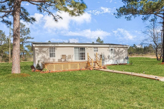 back of property featuring a lawn and a deck