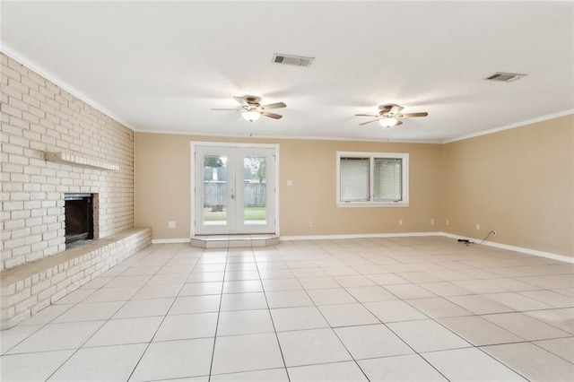 unfurnished living room featuring light tile patterned floors, crown molding, and a brick fireplace