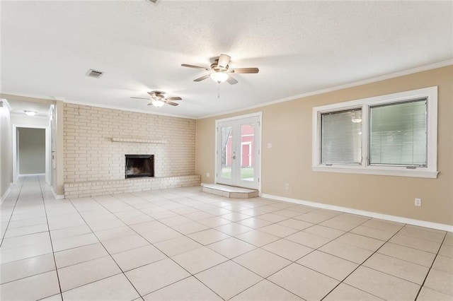 unfurnished living room with crown molding, ceiling fan, light tile patterned floors, a textured ceiling, and a fireplace