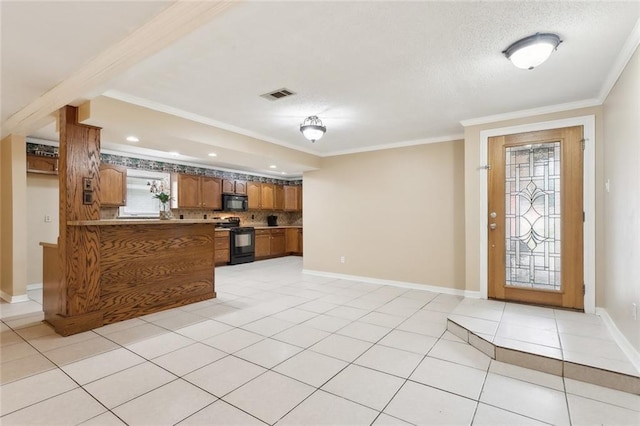 tiled foyer with a textured ceiling and ornamental molding