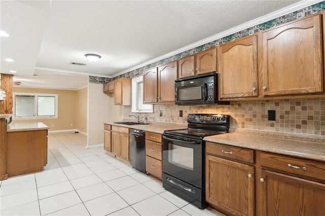 kitchen with black appliances, a healthy amount of sunlight, ornamental molding, and sink