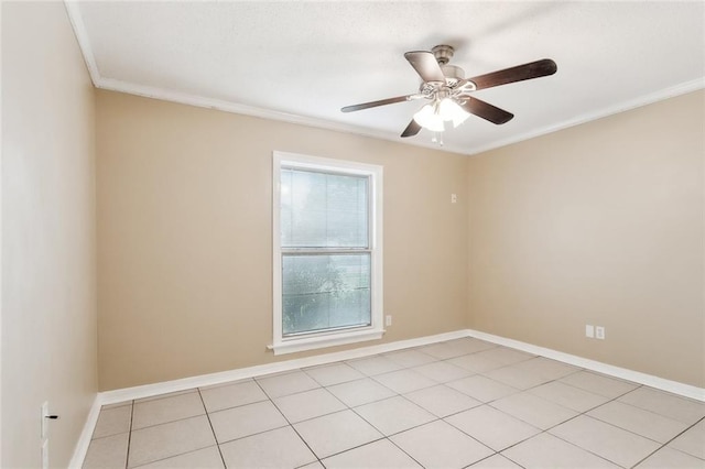 tiled spare room featuring crown molding and ceiling fan