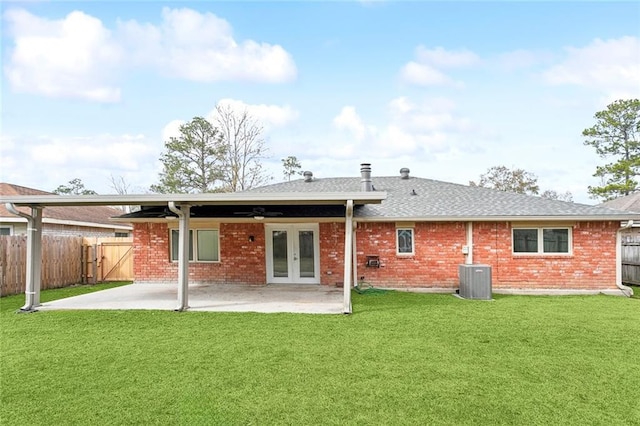 rear view of house featuring french doors, a patio, ceiling fan, and a lawn