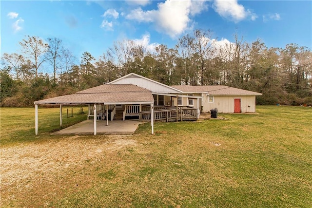 back of property featuring a deck and a lawn