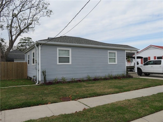 view of side of property with a lawn