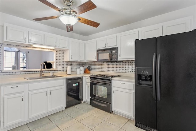 kitchen featuring backsplash, black appliances, white cabinets, sink, and light tile patterned floors