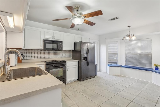 kitchen featuring white cabinetry, sink, tasteful backsplash, pendant lighting, and black appliances