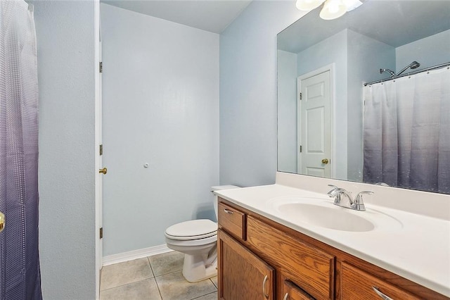 bathroom featuring tile patterned flooring, vanity, and toilet