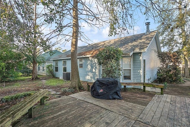 wooden deck with a grill and central air condition unit