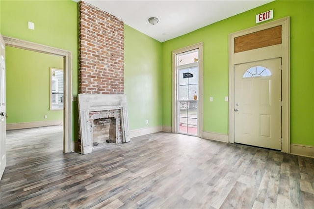 unfurnished living room featuring wood-type flooring and a fireplace