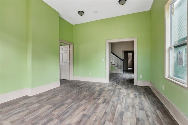 unfurnished room with hardwood / wood-style flooring