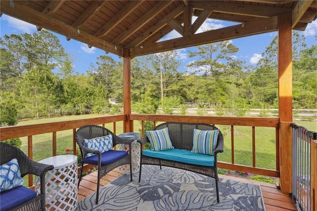 wooden terrace featuring a yard