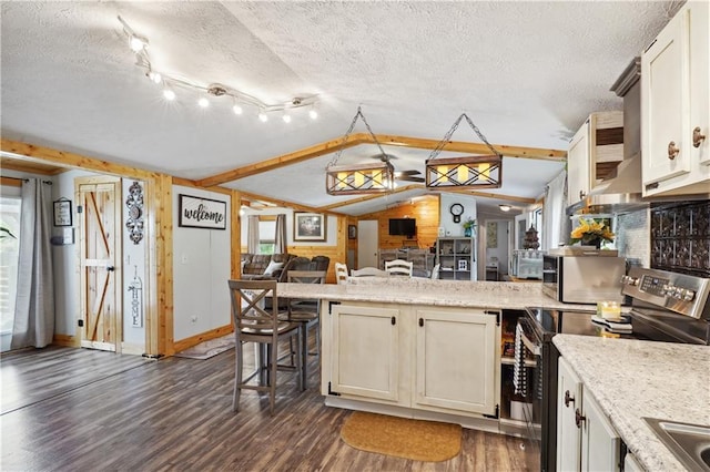 kitchen featuring dark wood-type flooring, a kitchen breakfast bar, vaulted ceiling, stainless steel electric stove, and wooden walls