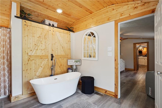 bathroom featuring hardwood / wood-style flooring, wooden ceiling, a bath, and vaulted ceiling