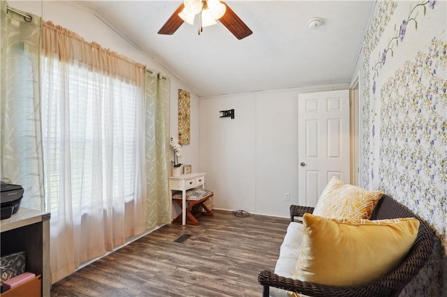 sitting room featuring ceiling fan, dark wood-type flooring, and vaulted ceiling