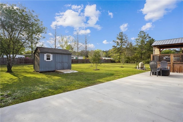 view of yard featuring a gazebo, a shed, and a patio