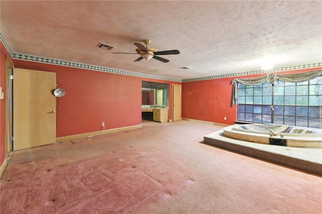 unfurnished living room with carpet, a textured ceiling, and ceiling fan