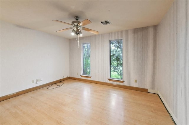 unfurnished room featuring ceiling fan and light hardwood / wood-style flooring