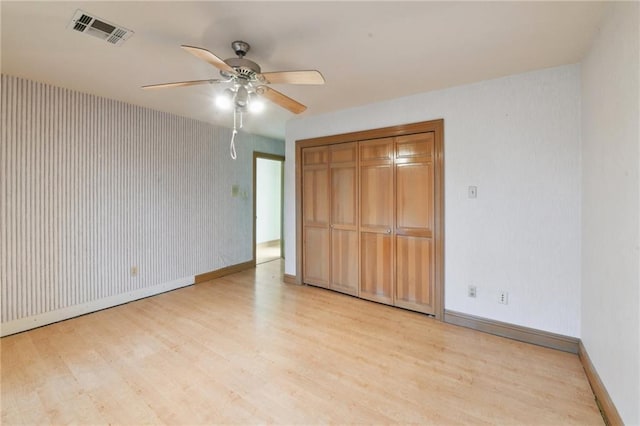 unfurnished bedroom featuring a closet, ceiling fan, and light hardwood / wood-style flooring