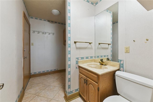 bathroom with vanity, tile patterned floors, a textured ceiling, and toilet