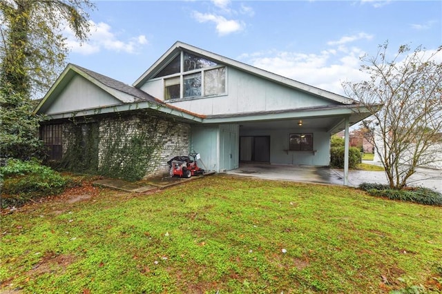 rear view of house with a carport and a lawn