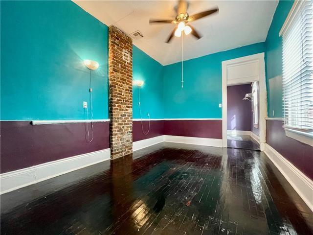 unfurnished room with ceiling fan and hardwood / wood-style flooring