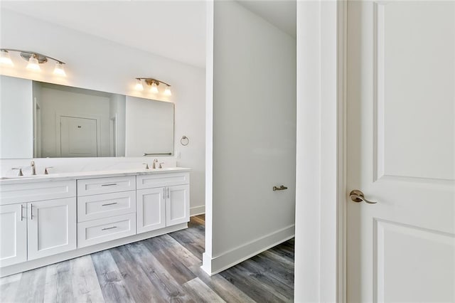 bathroom with hardwood / wood-style floors and vanity