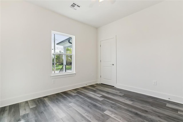 spare room featuring ceiling fan and dark hardwood / wood-style floors