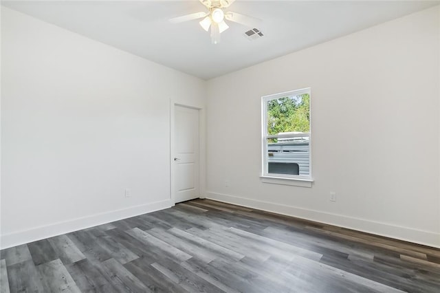 spare room featuring ceiling fan and dark hardwood / wood-style floors