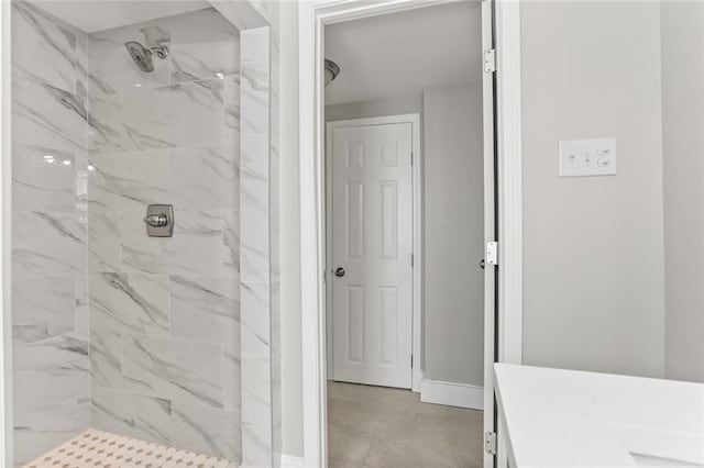 bathroom featuring vanity and tiled shower