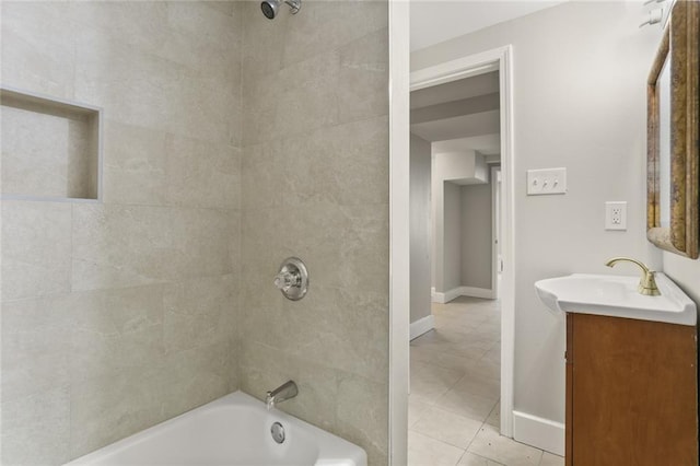 bathroom featuring tile patterned flooring, vanity, and tiled shower / bath combo