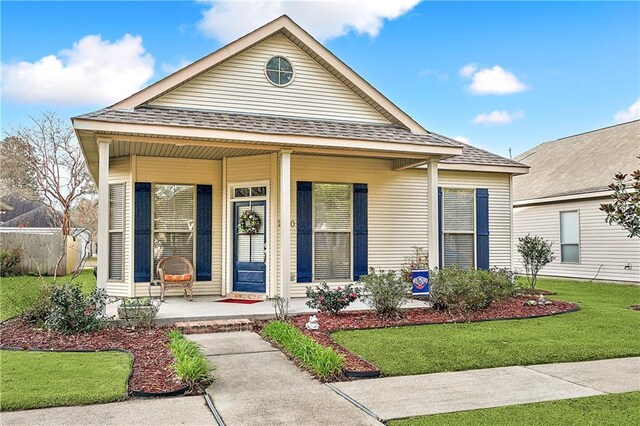 view of front of property with a porch and a front yard