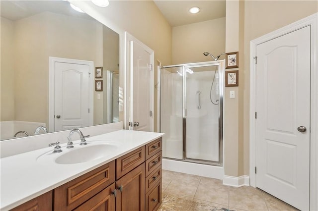 bathroom featuring vanity, walk in shower, and tile patterned flooring