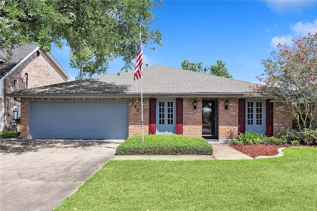 single story home featuring a garage and a front yard