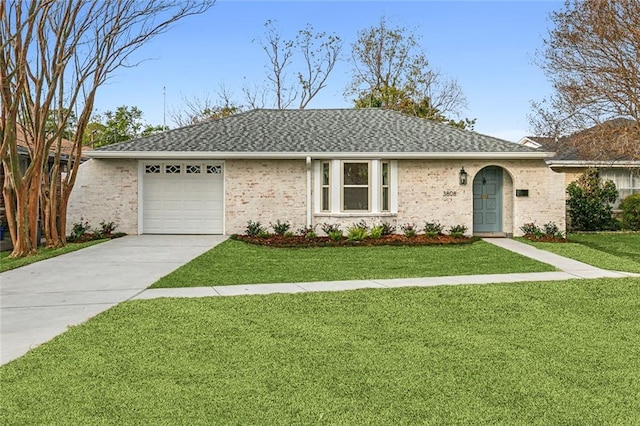 single story home featuring a garage and a front lawn