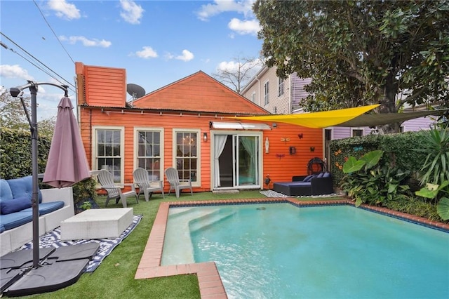 back of house featuring a yard and outdoor lounge area