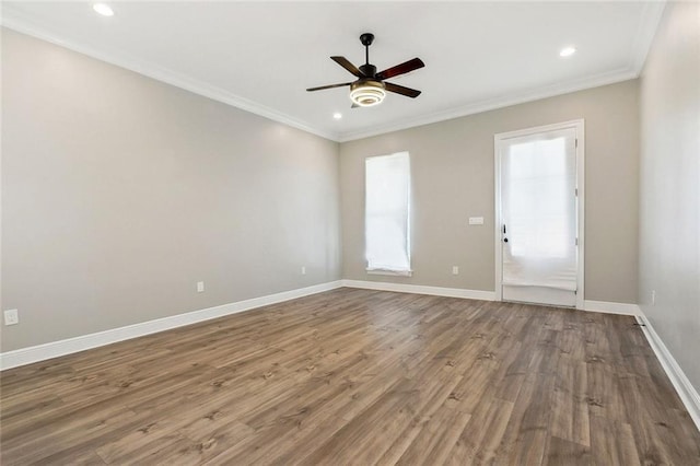 spare room featuring baseboards, a ceiling fan, wood finished floors, crown molding, and recessed lighting