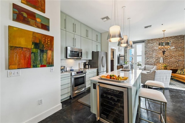 kitchen featuring hanging light fixtures, brick wall, wine cooler, backsplash, and appliances with stainless steel finishes